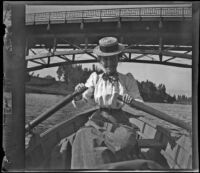 Daisy Kellum rows a boat on the lake at Hollenbeck Park, Los Angeles, about 1898