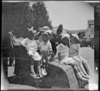 Frances Cline, Chester Schmitz, Kate Schmitz, Irene Schmitz and Frances West riding an Osborn Electriquette in Balboa Park, San Diego, [about 1915]