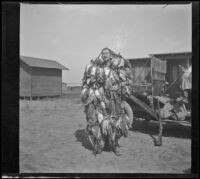 Dr. Ferguson S. Hardin poses with ducks piled on him, Orange County vicinity, 1909