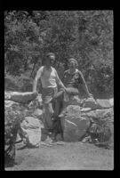 Glen Velzy and Nina Meyers pose in front of a stone wall, San Gabriel Mountains, 1941