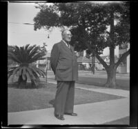 J. E. Smith stands on the front walkway outside his home, Los Angeles, 1943