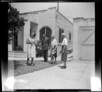 Mrs. Bacon, Mr. Robinson, Mrs. H. H. West with Tommie Newquist and Mrs. Robinson stand in front of the Newquists' residence, Los Angeles, 1948