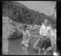 Frances Cline and Frances West play in Big Tujunga Creek, Sunland-Tujunga vicinity, 1912