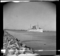 Catalina ferry sailing through a channel in San Pedro harbor, Los Angeles, about 1910