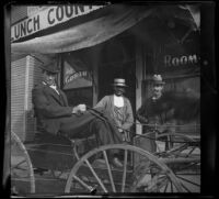 Carl Austin sits in a buggy while Will Longstreet and Sam Longstreet ...