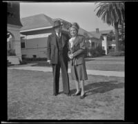 H. H. West and Mertie West pose on the front lawn of their home, Los Angeles, 1944