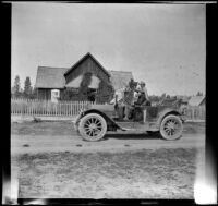 Harry Schmitz and Wilfrid Cline, Jr. sit in H. H. West's car while visiting the old Teel family ranch, Shasta County, 1917