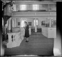 Mertie West reads a sign posted at the pulpit in Old South Meeting House, Boston, 1947