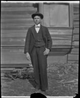 Guy West stands in front of the West's partially constructed house, Los Angeles, 1896