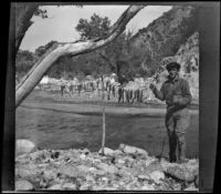 Winnie Scott posing with a string of fish, Los Padres National Forest vicinity, about 1917