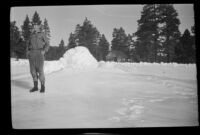 H. H. West, Jr. stands near a frozen fountain, Big Bear, 1932