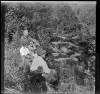 Forrest and Agnes Whitaker, Mertie West, and William Shaw sit by Pine Creek, Inyo County vicinity, about 1930