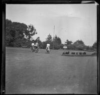 Three people ride bicycles through Golden Gate Park, San Francisco, 1900