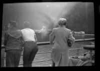 Frances Wells looks over the ship's rail on its approach to Orca, Cordova vicinity, 1946