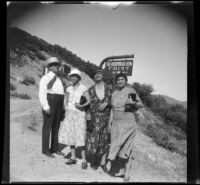 Will Shaw, Mertie West, Alice Prickett and Bertha Keether pose in front of a sign along a trail to Inspiration Point, Los Angeles County, 1932