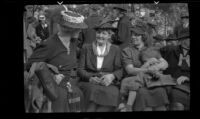 Laura Bell Gibson sits on a bench with other women at the Iowa Picnic in Lincoln Park, Los Angeles, 1939