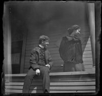 Earl Kellum and Daisy Kellum glance to the right while on their front porch, Los Angeles, about 1899