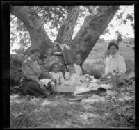 H. H. West's mother, wife, daughters, and sister eat a picnic in Chatsworth Park, Los Angeles, about 1910