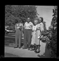 Charles Longstreet, Sam Longstreet, Mrs. Charles Longstreet and Mrs. George Pawley pose outside the Pawley residence on Maple Avenue, Pasadena, 1948