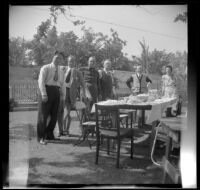 Everett Shaw, Hebard West, Lester Shaw, Will Shaw, J. W. McDonald and Chloe McDonald pose around a picnic table in the McDonalds' backyard, Burbank, 1948