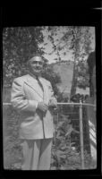 Sheriff Eugene Biscailuz poses next to a fence in Sycamore Grove Park, Los Angeles, 1945