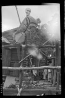 Skull and tiki mask at Disneyland at the entrance gate to Adventureland, Anaheim, 1957