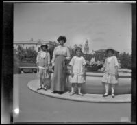 Elizabeth West, Minnie West, Frances Cline and Frances West posing in front of a fountain in Balboa Park, San Diego, [about 1915]