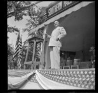 Worm's-eye view of Sheriff Eugene Biscailuz speaking at the Southern Pacific Railroad employee picnic, Los Angeles, 1945