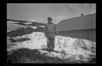 Fellow serviceman of H. H. West, Jr. poses with a rifle in the snow, Dutch Harbor, 1943