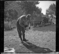 Dave F. Smith pouring the water off the potatoes, Inyo County, 1913