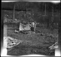 Wilfrid Cline, Jr. kneels on his camp bedding, Trinity County, 1917