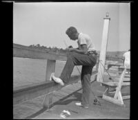 H. H. West Jr. prepares to fish off of the San Clemente Pier, San Clemente, 1936