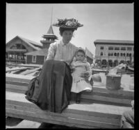 Mary West sits on a pile of wooden planks with her daughter, Elizabeth, Venice, about 1903