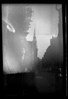 Mertie West poses on a sidewalk in the North End with Old North Church in the background, [Boston], 1947