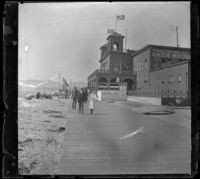 People walk on the boardwalk in front of the North Beach Bath House, Santa Monica, about 1895