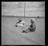 Elizabeth West and Wilfrid Cline Jr. play in the sand, Venice, about 1903