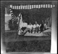 Elizabeth and Frances West pose in the backyard of the West's home with their cousin, Frances Cline and unknown boy, Los Angeles, about 1914