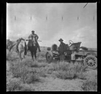 Leslie L. McAfee and Chet Edgell pose for a photograph while out hunting near Division Creek, Independence vicinity, 1916