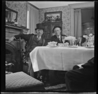 H. H. West and Dr. Bim Smith sit at the West's dining table during a birthday dinner, Los Angeles, 1944