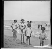 Frances West, Elizabeth West, Irene Schmitz and Chester Schmitz pose at the beach, Venice, [about 1915]