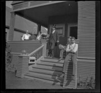 William Mead stands on the front porch of the West's house with the West family and the neighbor's maid, Los Angeles, about 1900