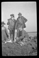 Keeper Hardy, Theodore "Pete" Lohman, H. H. West and Frank Mellus pose during a shoot, Seal Beach vicinity, 1916