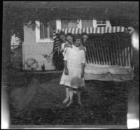 Elizabeth and Frances West pose in the backyard of the West's home with their cousin, Frances Cline and unknown boy, Los Angeles, about 1914