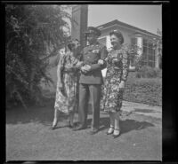 Elizabeth Siemsen, H. H. West, Jr. and Frances Wells pose on the front lawn of the Siemsen's residence, Glendale, 1944