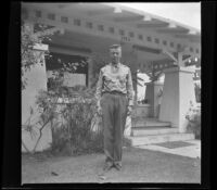 Lynn West stands in front of Wayne West's house, Santa Ana, 1942