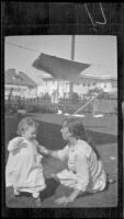 Elizabeth West plays with her baby brother, H. H. West Jr., in the West's backyard, Los Angeles, about 1919