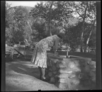 Hattie Whitaker bends over a drinking fountain in Victory Park, Los Angeles, 1931