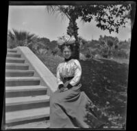 Daisy Kellum sits at the bottom of a set of steps in MacArthur (Westlake) Park, Los Angeles, about 1898