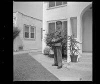 P.F.C. H. H. West, Jr. poses outside the West's new residence, Los Angeles, 1944