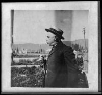 H. H. Cooper blowing out a dandelion, Sisson, about 1906